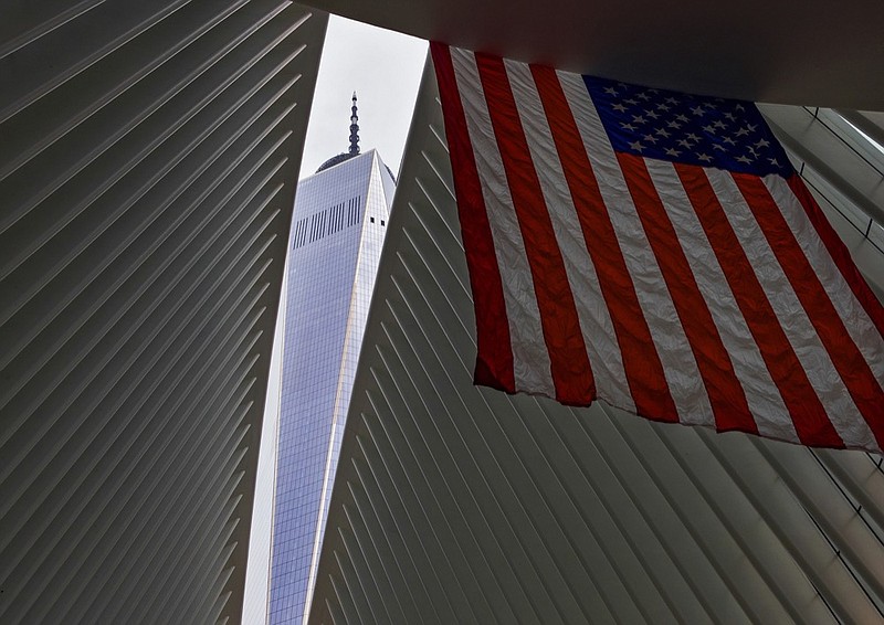 One World Trade Center appears through the open ceiling of the Oculus, part of the World Trade Center transportation hub in New York, Tuesday, Sept. 11, 2018, the anniversary of 9/11 terrorist attacks. The transit hall ceiling window was opened just before 10:28 a.m., marking the moment that the North Tower of the World Trade Center collapsed on September 11, 2001. (AP Photo/Craig Ruttle)

