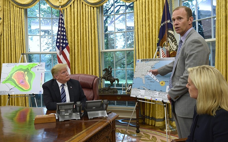 President Donald Trump, left, listens as FEMA Administrator Brock Long, center, talks about Hurricane Florence in the Oval Office of the White House in Washington, Tuesday, Sept. 11, 2018, with Homeland Security Secretary Kirstjen Nielsen, right. (AP Photo/Susan Walsh)

