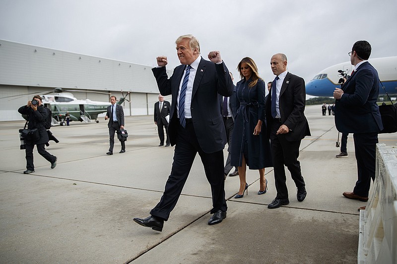 President Donald Trump pumps his fist as he greets supporters after landing at Johnstown-Cambria County Airport on Tuesday in Johnstown, Pa. (AP Photo/Evan Vucci)