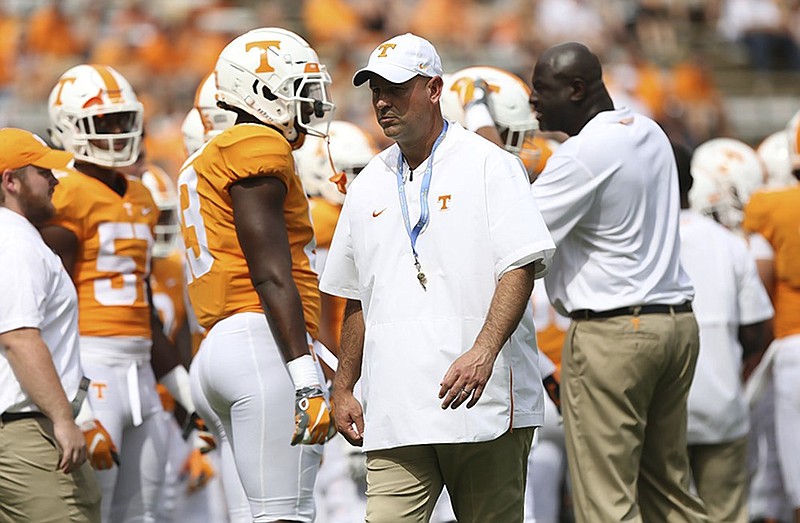 Tennessee football coach Jeremy Pruitt walks around between drills as the Vols warm up for their home game against ETSU this past Saturday.