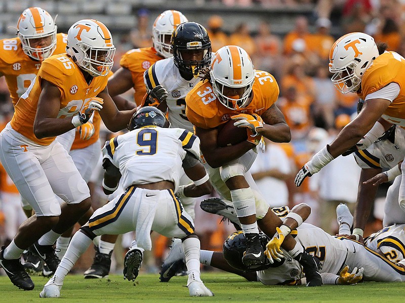 Tennessee running back Jeremy Banks (33) pushes through the ETSU defense during the second half of the Vols' 59-3 win last Saturday in Knoxville. Banks rushed for two touchdowns and 62 yards on 13 carries.