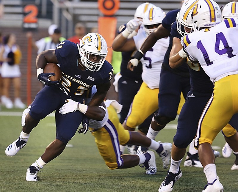 UTC running back Tyrell Price (23) breaks a tackle on the way to big yardage against Tennessee Tech on Aug. 30. He has run for 169 yards and three touchdowns in the Mocs' two wins.