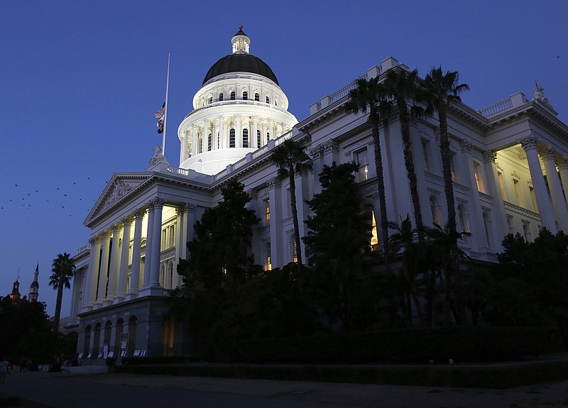 The lights of the capitol building in Sacramento, California, shine as lawmakers work into the night late last month before adjourning. (AP Photo/Rich Pedroncelli)