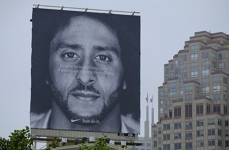 A large billboard showing Colin Kaepernick stands on top of the building housing the Nike store at Union Square Wednesday, Sept. 5, 2018, in San Francisco.