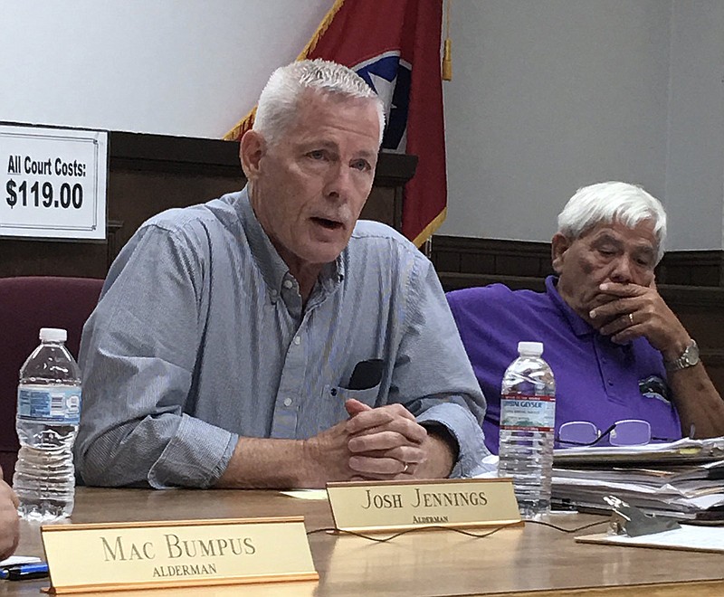 Jasper Alderman Paul West, left, and Mayor Paul Evans, right, talk during a meeting in August.