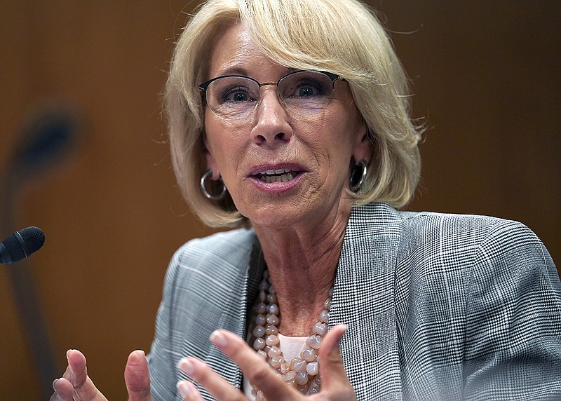 FILE - In this June 5, 2018, file photo, Education Secretary Betsy DeVos testifies during hearing on the FY19 budget on Capitol Hill in Washington. A federal court has ruled that a decision by DeVos to delay an Obama-era rule meant to protect students swindled by for-profit colleges was "arbitrary and capricious," dealing a significant blow to the Trump administration's attempt to ease regulations for the industry.   (AP Photo/Carolyn Kaster, File)