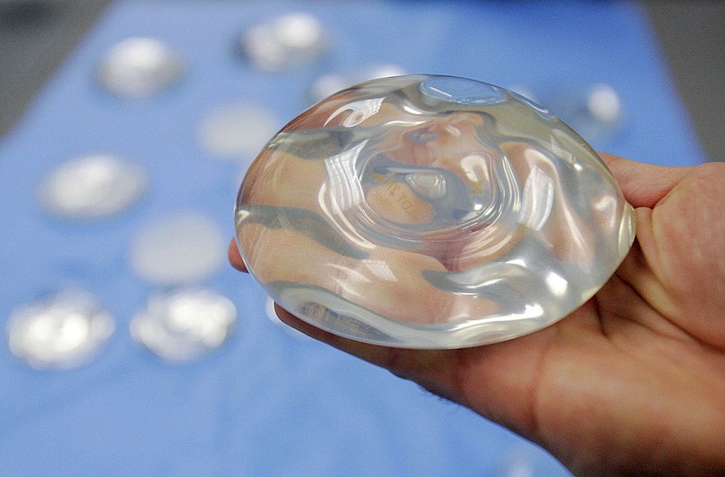 FILE - This Dec. 11, 2006, file photo shows a silicone gel breast implant at a manufacturing facility in Irving, Texas. On Friday, Sept. 14, 2018, U.S. health officials said they will convene a public meeting of medical advisers in 2019 on the safety of breast implants because of growing science on the topic, including an independent analysis that suggests certain rare health problems might be more common in women with implants containing silicone gel. (AP Photo/Donna McWilliam, File)