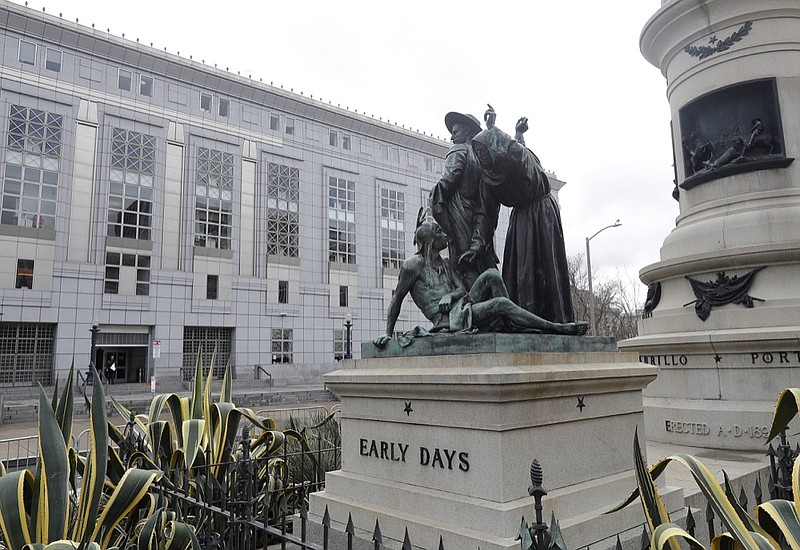 FILE - This March 2, 2018 file photo shows a statue that depicts a Native American at the feet of a Spanish cowboy and Catholic missionary in San Francisco. A San Francisco board has decided to remove the 19th-century statue that activists say is racist and demeaning to indigenous people. The San Francisco Board of Appeals voted Wednesday, Sept. 12, 2018, on the "Early Days" statue. (AP Photo/Jeff Chiu, File)

