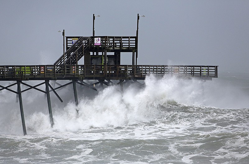 Waves from Hurricane Florence pound the Bogue Inlet Pier in Emerald Isle N.C., Thursday, Sept. 13, 2018. (AP Photo/Tom Copeland)