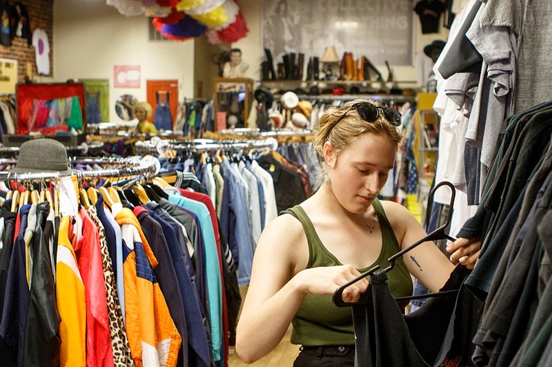 Staff photo by C.B. Schmelter / 
Kate Devore browses T-shirts at Collective Clothing on Thursday, Aug. 30, 2018 in Chattanooga, Tenn. Resale is growing 24 times faster than retail in the U.S. according to thredUp 2018 Resale Report.
