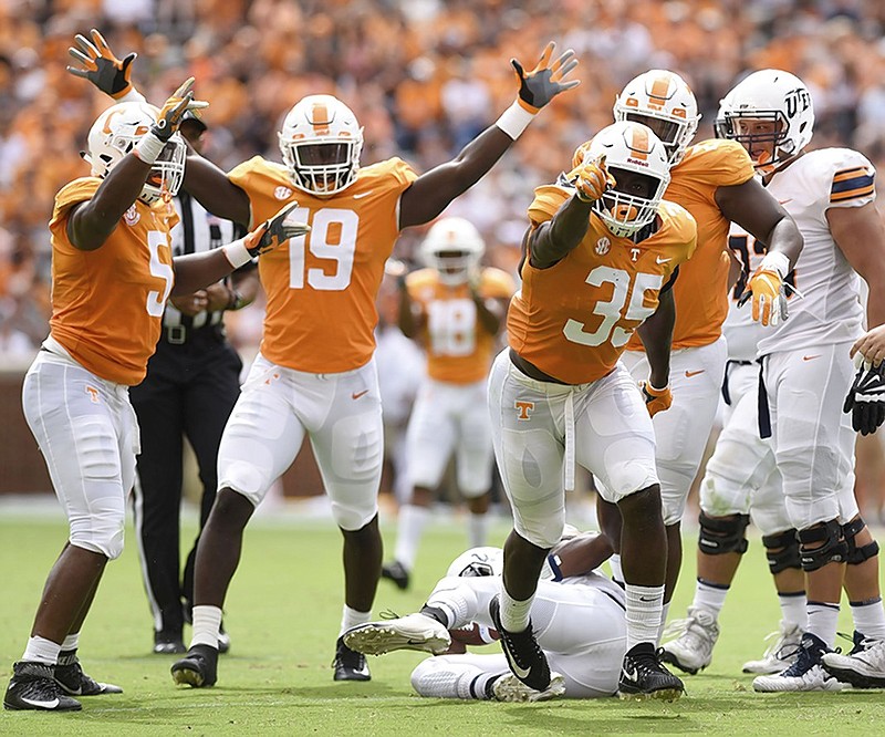 Tennessee's Kyle Phillips (5) and Darrell Taylor (19) celebrate teammate Daniel Bitull's (35) sack during the Vols 24-0 win against UTEP on Saturday in Knoxville.