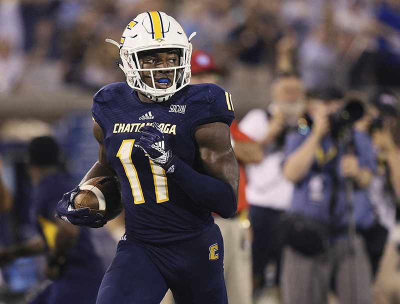 UTC wide receiver Wil Young looks over his shoulder as he heads into the end zone for a 63-yard touchdown catch in the season-opening win against Tennessee Tech.