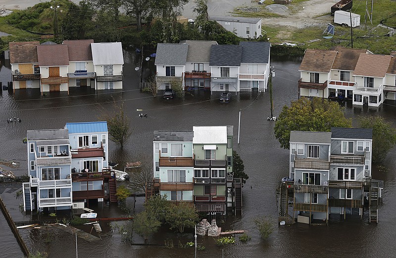 Homes along the New River are flooded as a result of high tides and rain from hurricane Florence which moved through the area in Jacksonville, N.C., Sunday, Sept. 16, 2018. (AP Photo/Steve Helber)