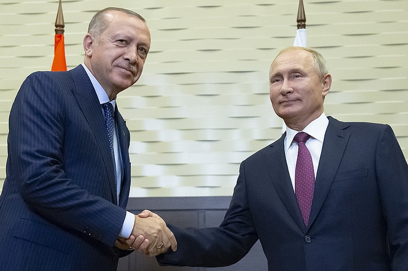 Russian President Vladimir Putin, right, and Turkish President Recep Tayyip Erdogan shake hands during their meeting in the Bocharov Ruchei residence in the Black Sea resort of Sochi in Sochi, Russia, Monday, Sept. 17, 2018. The presidents of Russia and Turkey are meeting in the Russian Black Sea resort of Sochi on Monday in a bid to find a diplomatic resolution to the crisis around a rebel-held region in Syria. (AP Photo/Alexander Zemlianichenko, Pool)