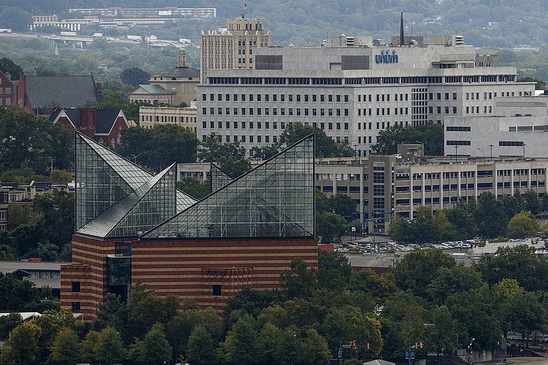 The Unum building is visible behind the Tennessee Aquarium on Wednesday, Sept. 13, 2017, in Chattanooga, Tenn. Rainy weather brought by hurricane Irma to the region lingered Wednesday.