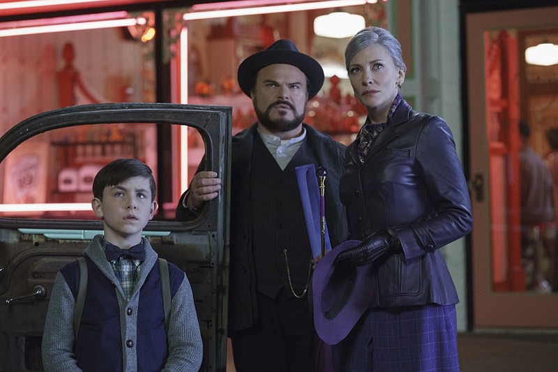 This image released by Universal Pictures shows Owen Vaccaro, from left, Jack Black and Cate Blanchett in a scene from "The House With A Clock in Its Walls." (Quantrell D. Colbert/Universal Pictures via AP)