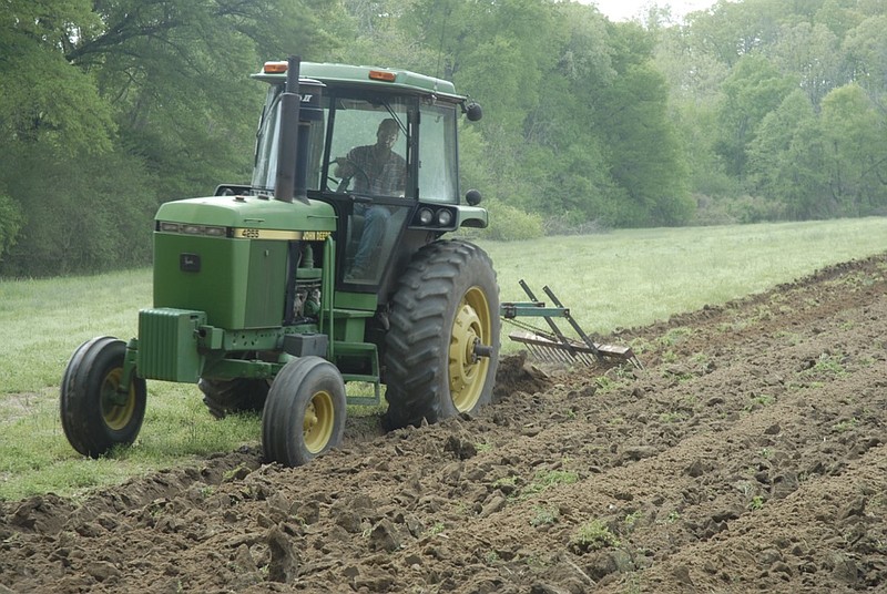 In this 2010 2010 staff file photo, Brad Swancy deep plows a field to plant white corn at Riverview Farms in Ranger, Ga. 