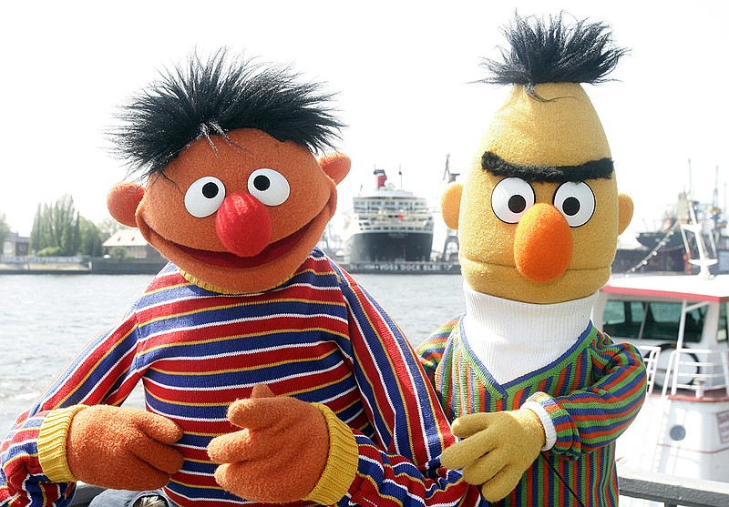 In this May 9, 2006, file photo, Ernie and Bert of "Sesame Street" pose in front of the Queen Mary II in the harbor of Hamburg, Germany. The producers of "Sesame Street" tweeted Tuesday, Sept. 18, 2018, that Bert and Ernie are not gay in response to a Queerty interview published Sunday, Sept. 16, 2018, with a former writer for the show who said he considered the puppets lovers. (AP Photo/Fabian Bimmer, File)