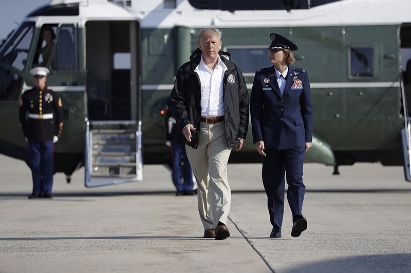President Donald Trump walks to board Air Force One for a trip to tour areas impacted by Hurricane Florence, Wednesday, Sept. 19, 2018, in Andrews Air Force Base, Md. (AP Photo/Evan Vucci)

