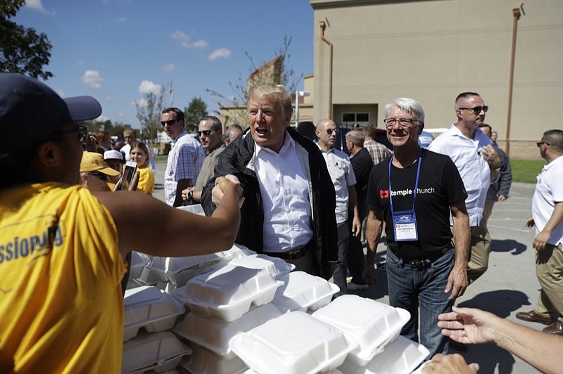 President Donald Trump visits the Temple Baptist Church, where food and other supplies are being distributed during Hurricane Florence recovery efforts, Wednesday, Sept. 19, 2018, in New Bern, N.C. (AP Photo/Evan Vucci)

