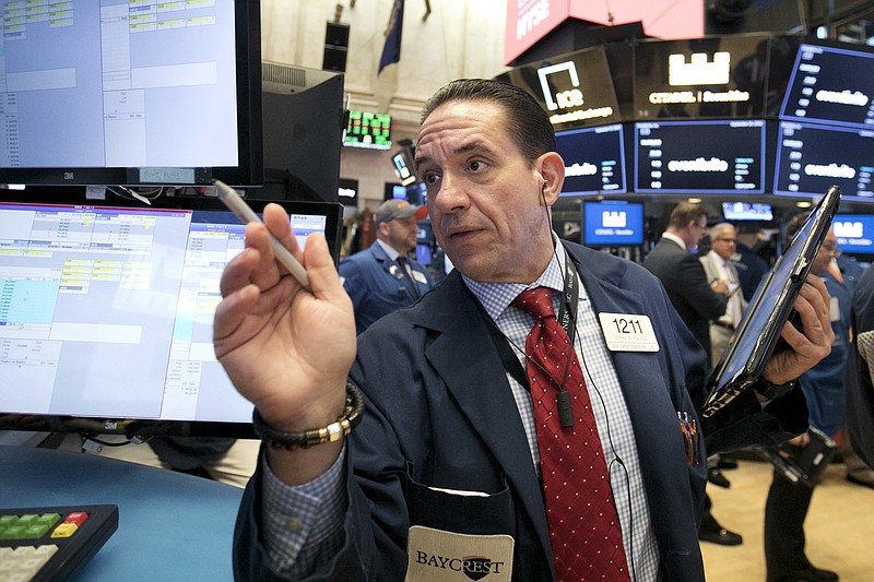 Trader Tommy Kalikas works on the floor of the New York Stock Exchange, Thursday, Sept. 20, 2018. A wave of buying sent U.S. stocks solidly higher on Wall Street Thursday, pushing the Dow Jones Industrial Average above the all-time high it closed at in January. (AP Photo/Richard Drew)