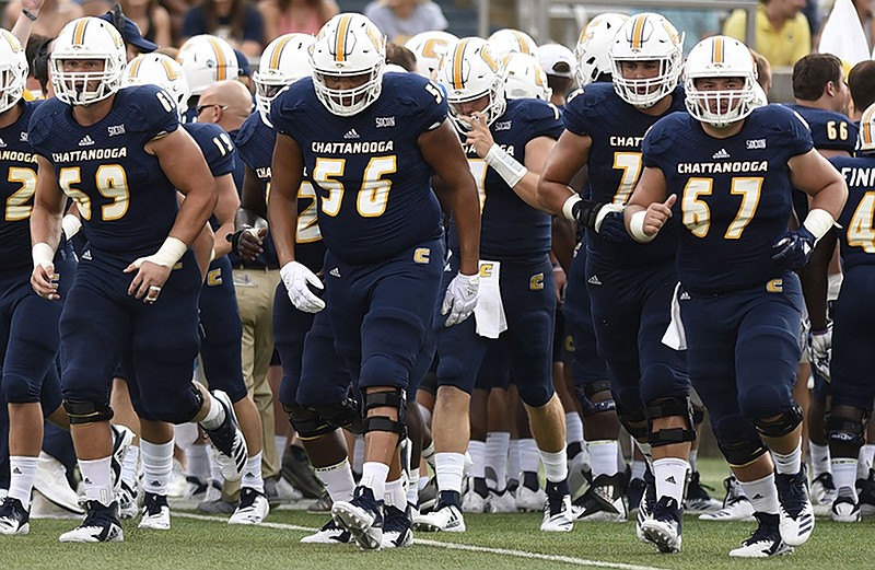 From left, UTC offensive linemen Cole Strange (69), Malcolm White (56) and Noah Ramsey (67) take the field for the season opener against Tennesee Tech on Aug. 30 at Finley Stadium. The Mocs host Samford there Saturday night.