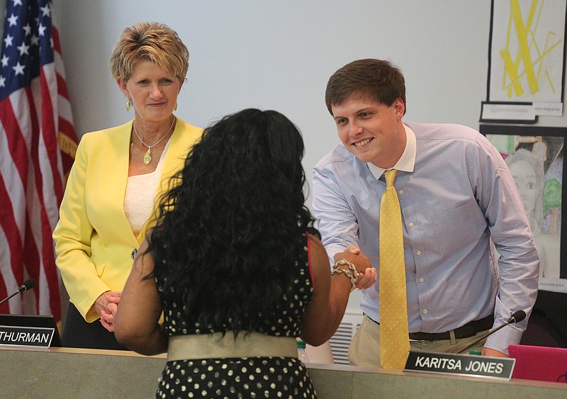 Marthel Young, the principal at East Brainerd Elementary, shakes hands with Hamilton County School Board members Rhonda Thurman and Tucker McClendon as she is recognized for being Principal of the Year Thursday, September 20, 2018 at the Hamilton County Department of Education in Chattanooga, Tennessee.