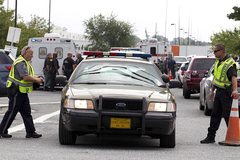 Aberdeen police officers blocks the entrance of industrial complex where several people had been shot, in Harford County, Md, Thursday, Sept. 20, 2018. Authorities say multiple people have been shot in northeast Maryland in what the FBI is describing as an "active shooter situation." (AP Photo/Jose Luis Magana)