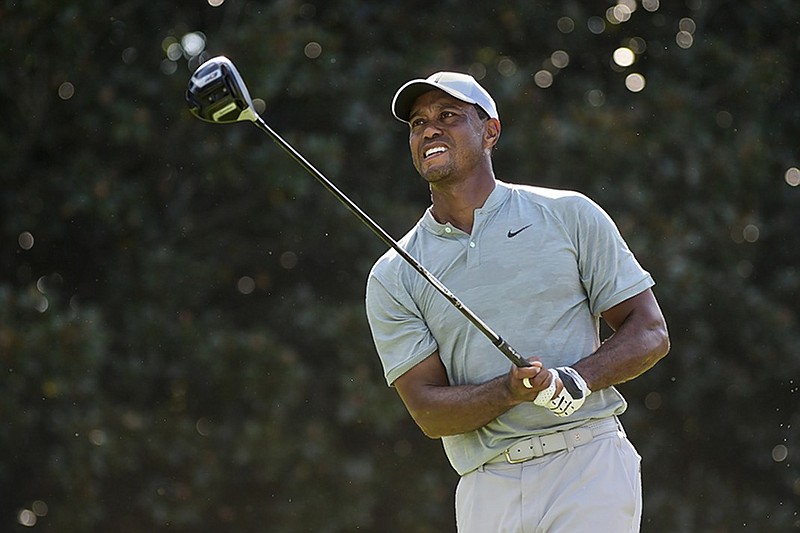 Tiger Woods tees off on the 14th hole at Atlanta's East Lake Golf Club during Friday's second round of the Tour Championship. Woods shot a 2-under-par 68 and shared the 36-hole lead with Justin Rose (67) at 7 under.