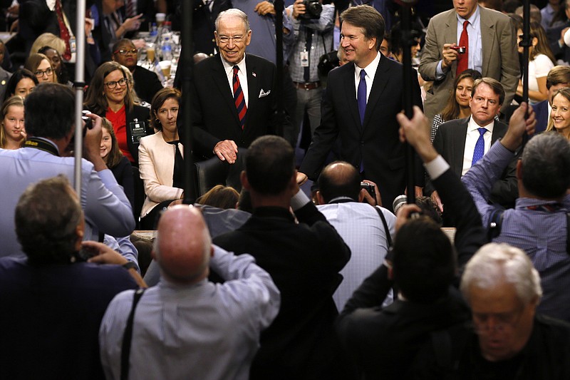 U.S. Supreme Court nominee Judge Brett Kavanaugh is surrounded by photographers as he stands with Senate Judiciary Committee Chairman Charles Grassley during Kavanaugh's confirmation hearing on Capitol Hill in Washington on Sept. 4. REUTERS/Jim Bourg/Pool