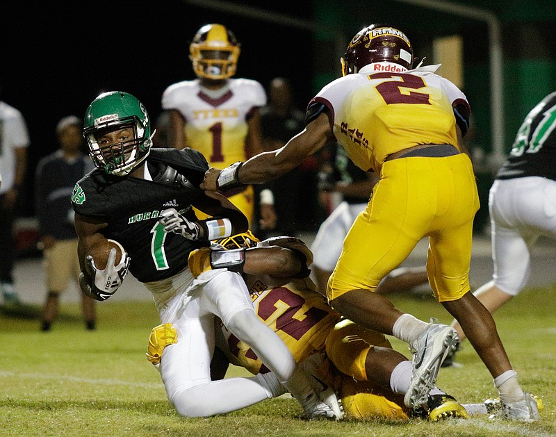 Tyner's Kamden Edwards (32) tackles East Hamilton's Kyler Johnson (1) during their prep football game at East Hamilton High School on Friday, Sept. 21, 2018, in Chattanooga, Tenn. 