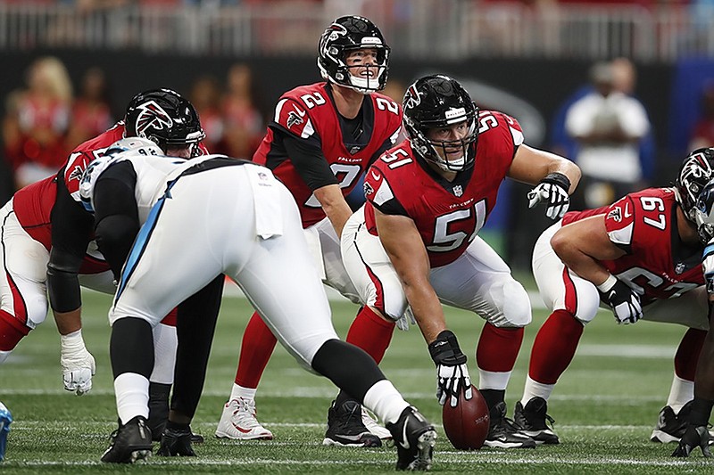 AP file photo / Atlanta quarterback Matt Ryan (2) and center Alex Mack (51) look over the Carolina Panthers defense.