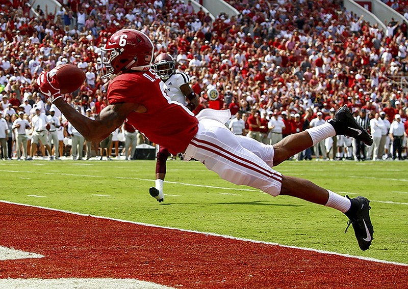 Alabama wide receiver DeVonta Smith catches a 30-yard touchdown pass from Tua Tagovailoa during Saturday's 45-23 home win against Texas A&M.