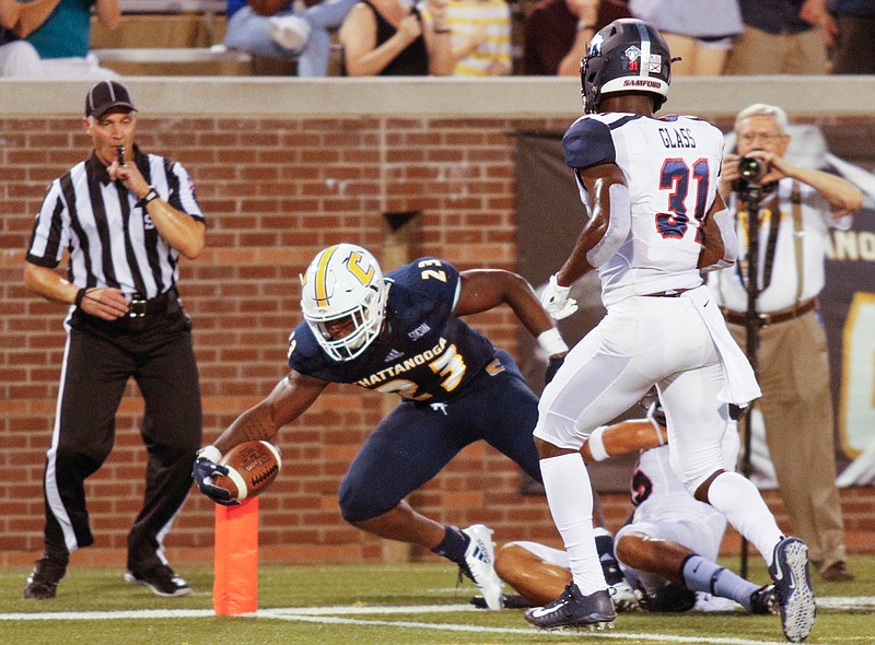 UTC running back Tyrell Price (23) stretches for a touchdown ahead of Samford defensive back Jamond Glass (31) during the Mocs' home football game against the Samford Bulldogs at Finley Stadium on Saturday, Sept. 22, 2018, in Chattanooga, Tenn. 