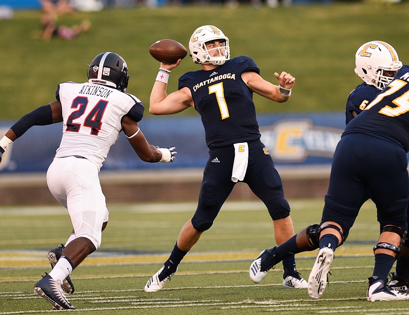 UTC quarterback Nick Tiano (7) passes under pressure from Samford linebacker Aaron Atkinson (24) during a home game on Sept. 22. 