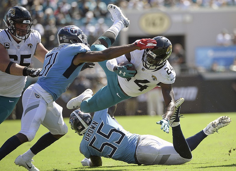 Jacksonville Jaguars running back T.J. Yeldon is upended by Tennessee Titans linebacker Jayon Brown during the second half of Sunday's game. Yeldon had 44 rushing yards on seven carries as the Jaguars lost to the Titans for the fifth time in their past six meetings.