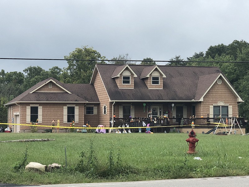 Crime scene tape encloses the front yard of a home on Monday, Sept. 24, 2018, where a shooting took place the day before along State Route 108 in Altamont, Tennessee. A woman was killed and three men, including the shooter, were injured, one critically. (Photo by Rosana Hughes)