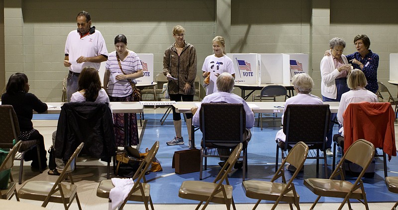 People check in with poll workers before voting on Election Day in August at Concord Baptist Church.