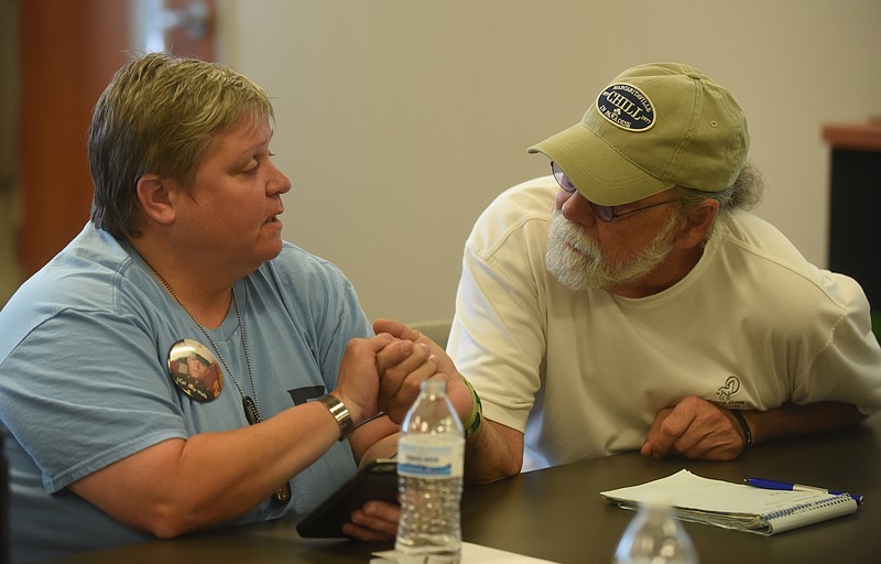 Staff photo by Angela Lewis Foster /
Don Goodman, right, offers support to Cathy Wells during an Operation Song meeting at the Chattanooga Lifestyle Center July 6, 2016. 