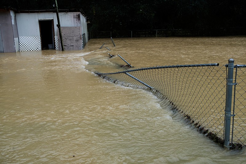 Floodwaters erode a fence on Dallas Hollow Road after heavy rainfall on Wednesday, Sept. 26, 2018, in Soddy-Daisy, Tenn. Heavy rains throughout the week caused flooding and closed schools across the region.