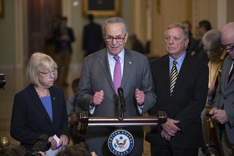 Senate Minority Leader Chuck Schumer, D-New York, joined by Sen. Patty Murray, D-Washington, left, and Sen. Dick Durbin, D-Illinois, meets with reporters about the confirmation for President Donald Trump's Supreme Court nominee, Brett Kavanaugh, following a weekly closed-door policy meeting, at the Capitol in Washington on Sept. 25. (AP Photo/J. Scott Applewhite)