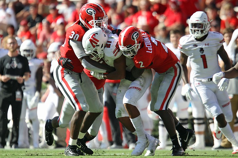 Georgia inside linebacker Tae Crowder (30) and safety Richard LeCounte (2) combine to tackle Austin Peay running back Ahmaad Tanner, who played at Dalton High School. The Bulldogs had allowed an average of 101 rushing yards a game this season before yielding 172 last Saturday at Missouri.