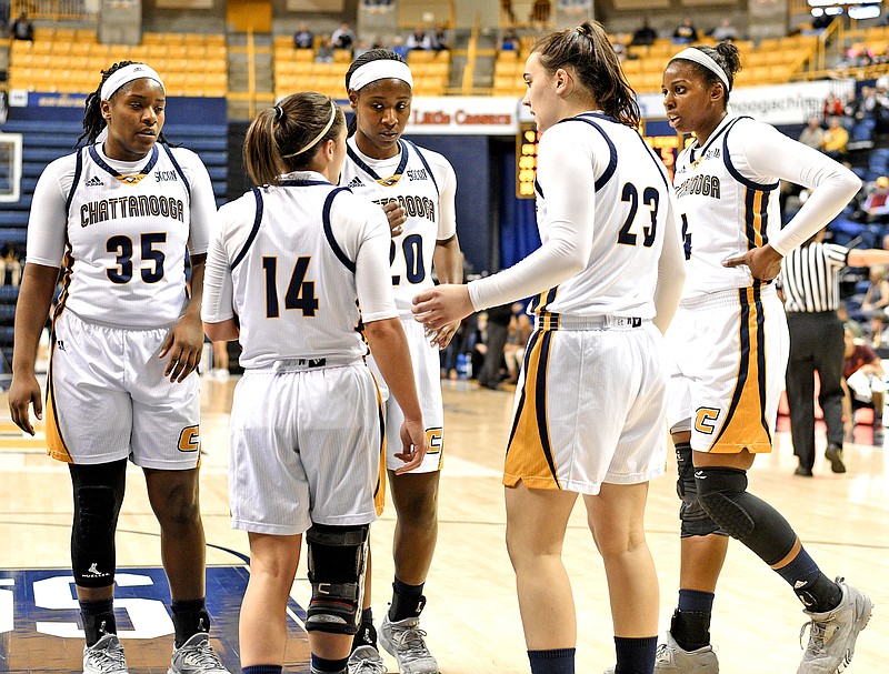 From left, Aryanna Gilbert, Molly Melton, Keiana Gilbert, Brooke Burns and Arianne Whitaker confer before Melton goes to the foul line during a game against Virginia Tech last December at McKenzie Arena.