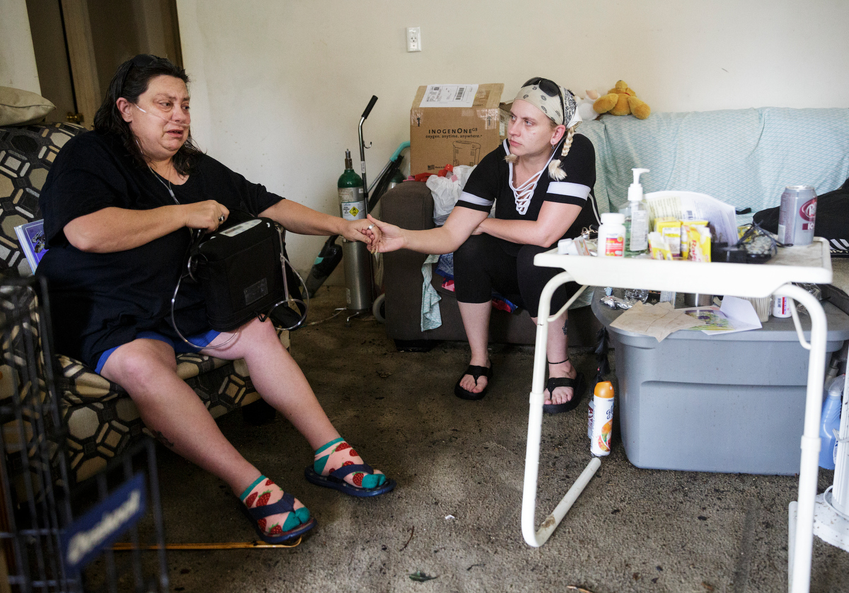 Joni Allen, right, comforts her mother Nancy Layne inside their flooded home one day after a deadly flash flood in the Depot Street area on Thursday, Sept. 27, 2018, in Soddy-Daisy, Tenn. Residents, volunteers and business owners returned Thursday following the flooding which killed one person Wednesday.