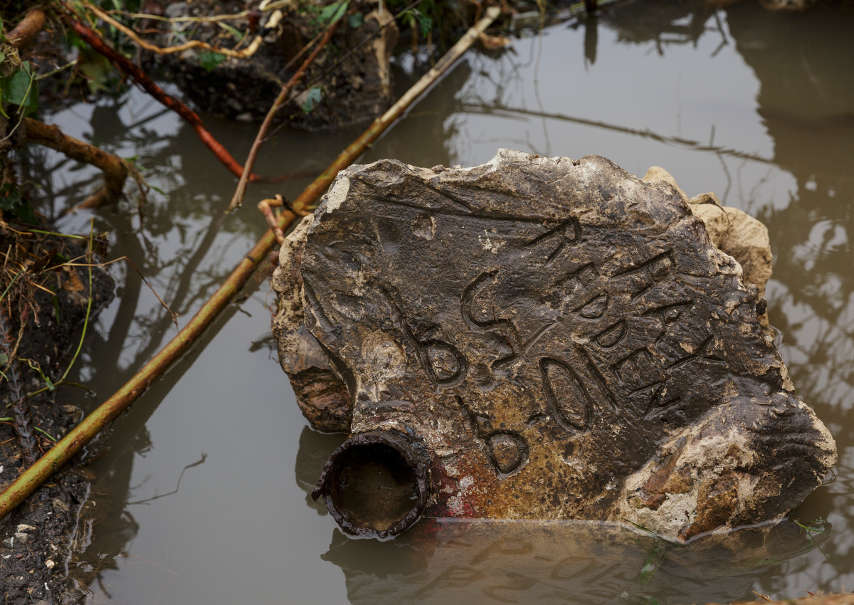 A name is written on a concrete support that washed away one day after a deadly flash flood in the Depot Street area on Thursday, Sept. 27, 2018, in Soddy-Daisy, Tenn. Residents, volunteers and business owners returned Thursday following the flooding which killed one person Wednesday.