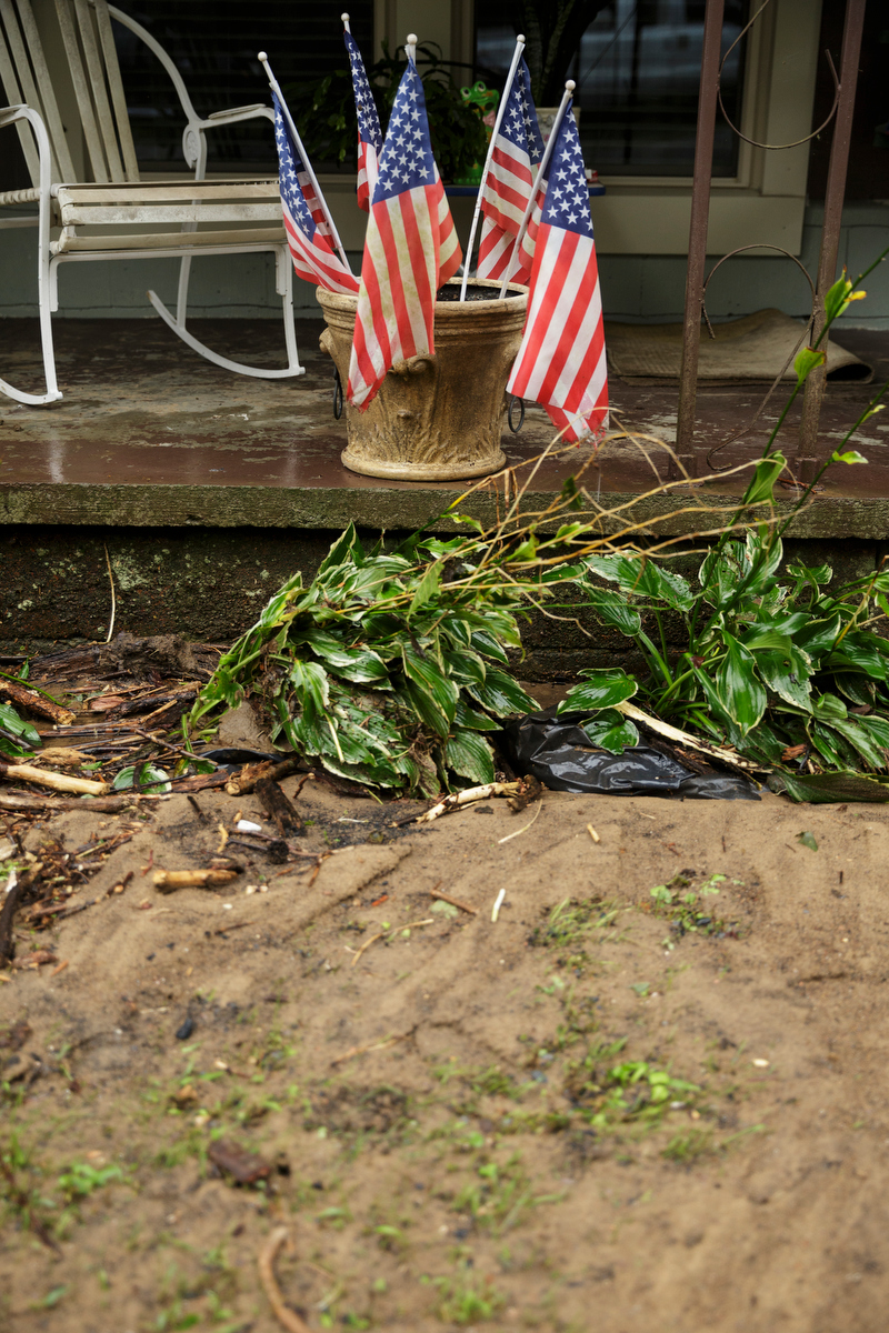 American flags remain in a flower pot outside of a flooded home one day after a deadly flash flood in the Depot Street area on Thursday, Sept. 27, 2018, in Soddy-Daisy, Tenn. Residents, volunteers and business owners returned Thursday following the flooding which killed one person Wednesday.