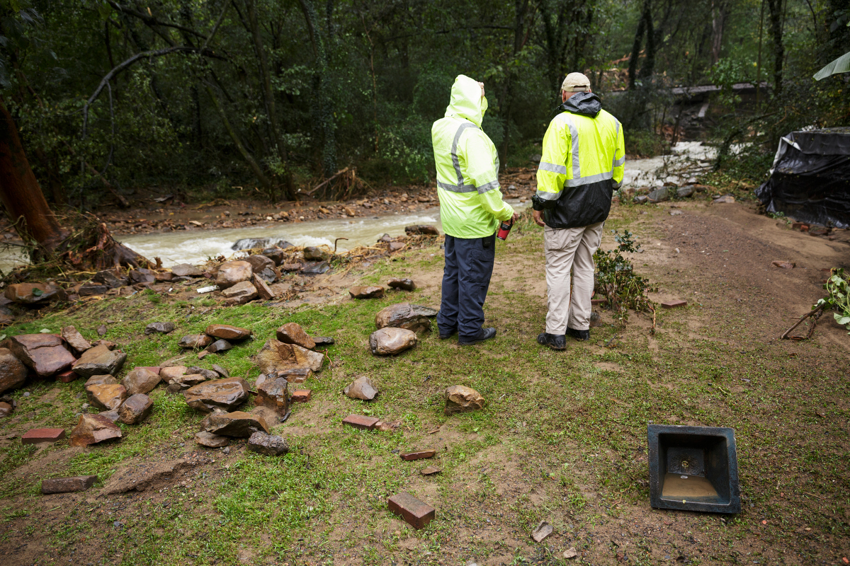 Soddy-Daisy Police Sgt. Mike Brown, right, and fire chief Mike Guffey survey Little Soddy Creek one day after a deadly flash flood in the Depot Street area on Thursday, Sept. 27, 2018, in Soddy-Daisy, Tenn. Residents, volunteers and business owners returned Thursday following the flooding which killed one person Wednesday.