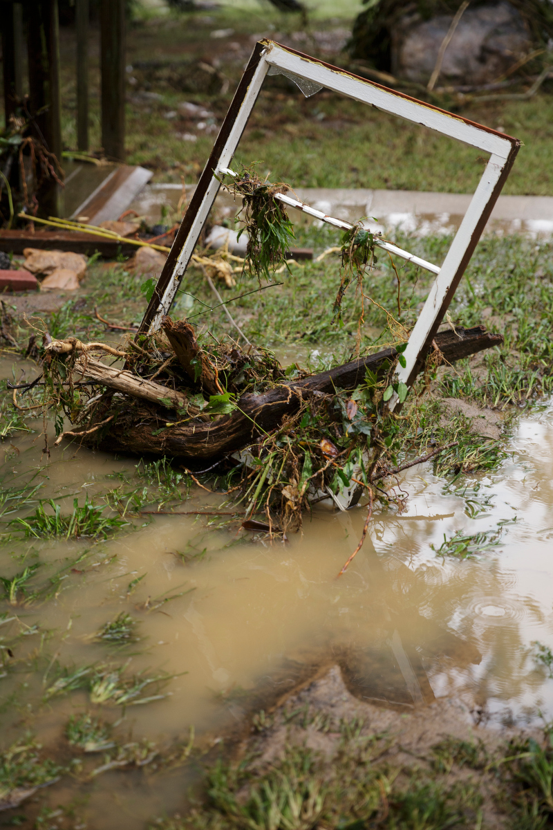 A broken window frame covered with debris sits upright in floodwaters one day after a deadly flash flood in the Depot Street area on Thursday, Sept. 27, 2018, in Soddy-Daisy, Tenn. Residents, volunteers and business owners returned Thursday following the flooding which killed one person Wednesday.