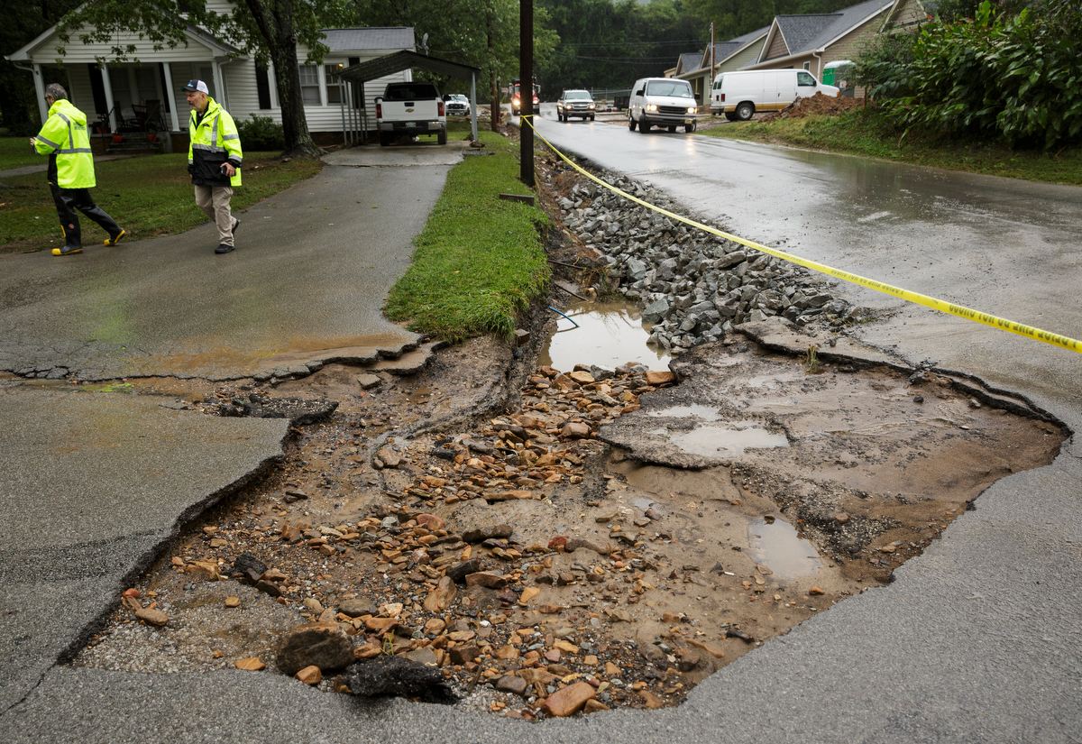 Hamilton County emergency workers survey damage near a washed-out section of road one day after a deadly flash flood in the Depot Street area on Thursday, Sept. 27, 2018, in Soddy-Daisy, Tenn. Residents, volunteers and business owners returned Thursday following the flooding which killed one person Wednesday.
