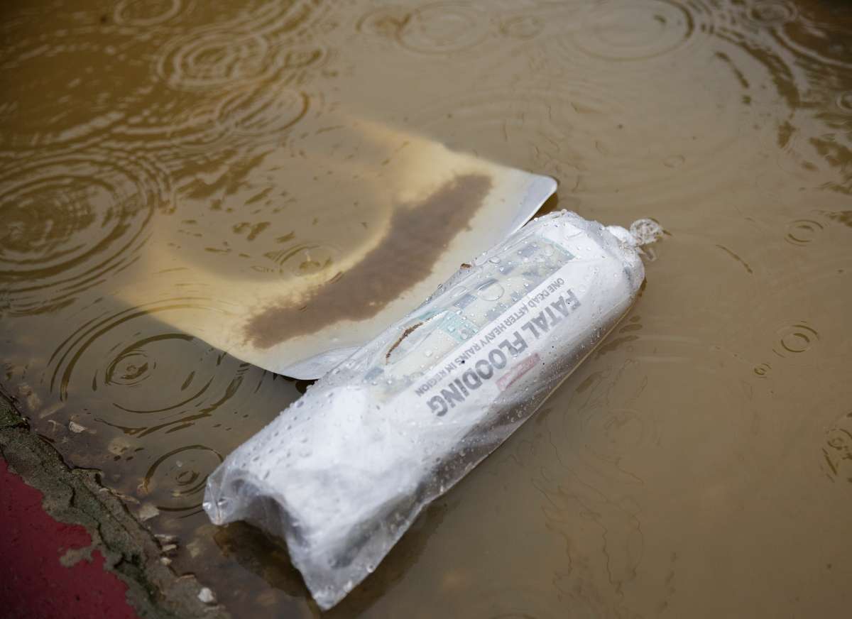 A newspaper floats in floodwaters one day after a deadly flash flood in the Depot Street area on Thursday, Sept. 27, 2018, in Soddy-Daisy, Tenn. Residents, volunteers and business owners returned Thursday following the flooding which killed one person Wednesday.